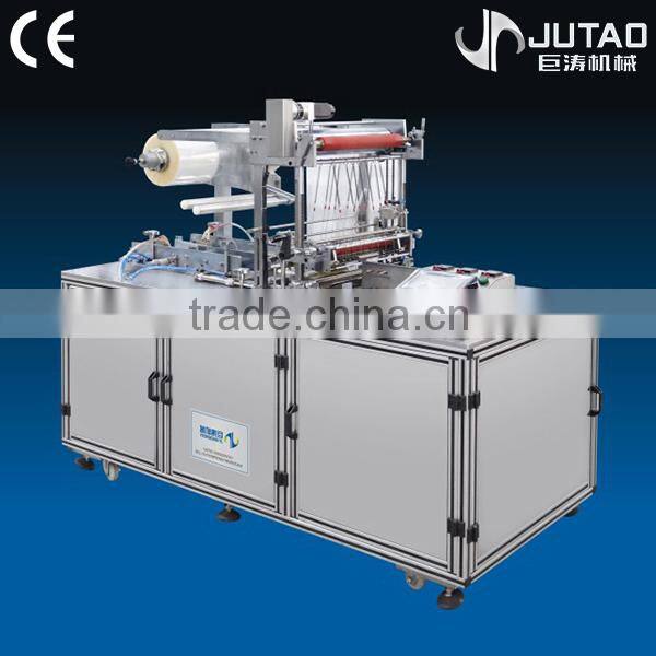Automatic transparent shrink packaging machine