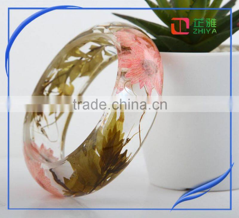 Pine needles inside transparent clear acrylic bangle stand