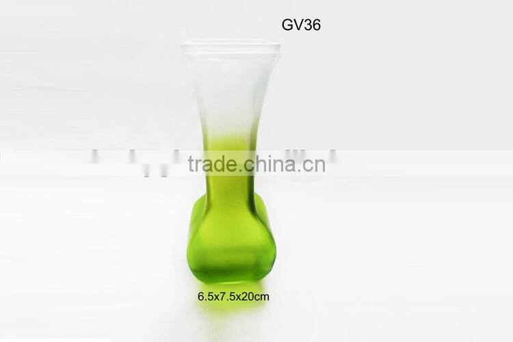 green artificial flowers glass vase