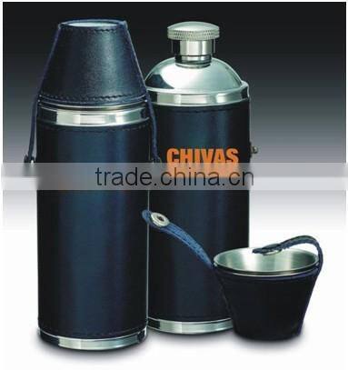 Cylindrical shape and suture and leather wrapped bottle and 2 glasses