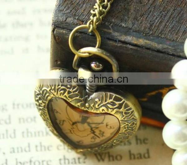 Cutting transparent glass heart shaped old pocket watch