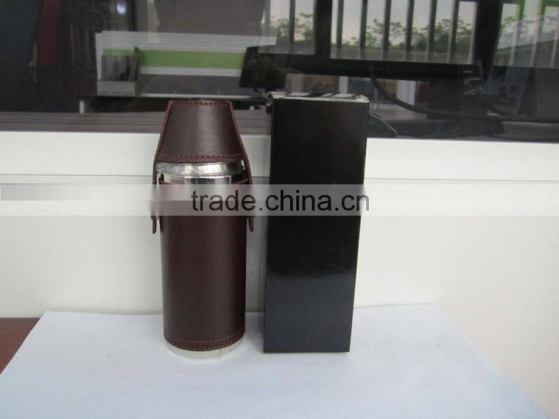 Cylindrical shape and suture and leather wrapped bottle and 2 glasses