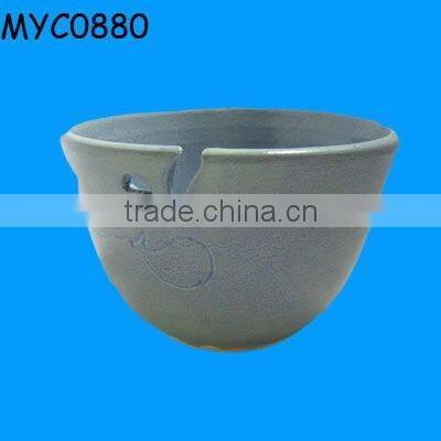 Ceramic pink bowl as yarn closet organizer