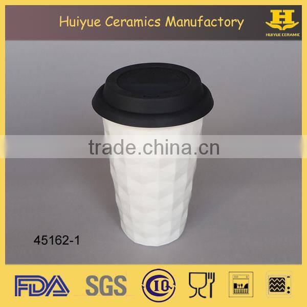 Insulated double wall embossed ceramic travel mug with silicone lid