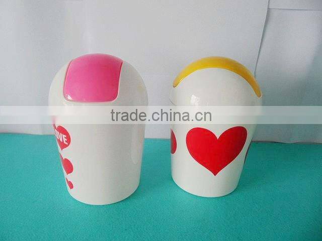 Round swing-top plastic trash can