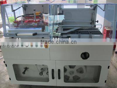 Vertical L type shrink wrapping machine