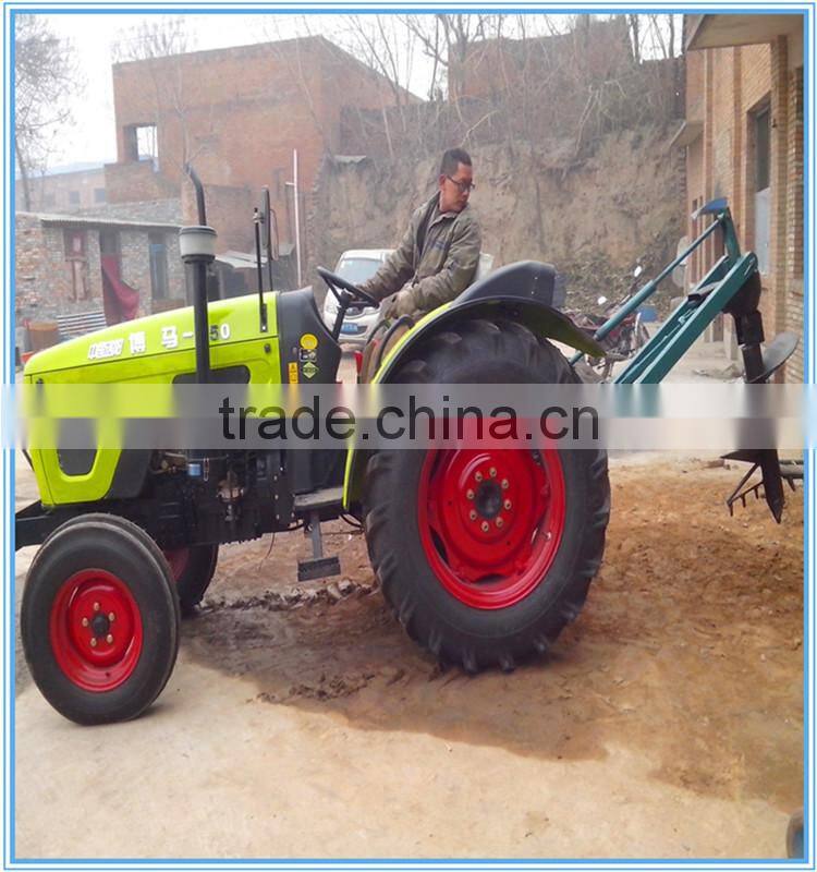 Hydraul earth digger post on tractor with crane mounded