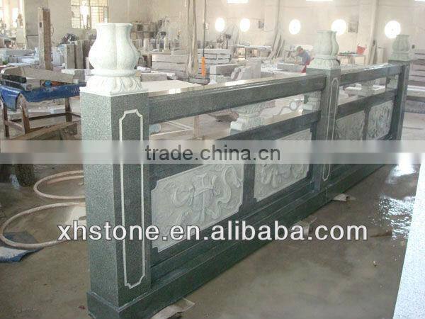outdoor black stone handrail with carving statues