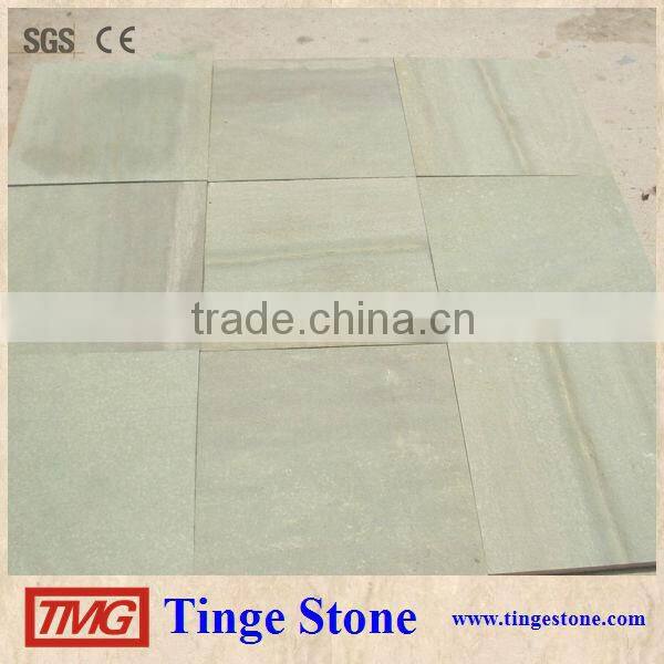 Cut to size green sandstone tiles and brick for paving