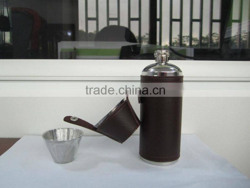 Cylindrical shape and suture and leather wrapped bottle and 2 glasses