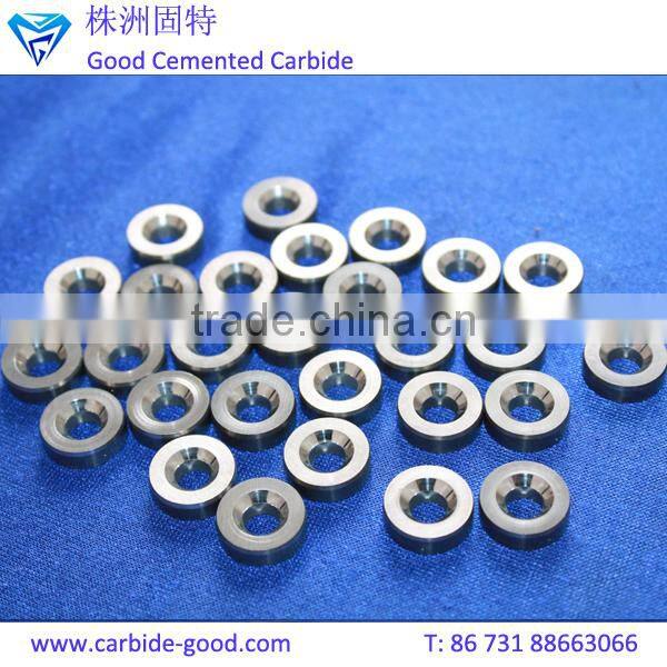 Discharge valve seat made from tungsten carbide