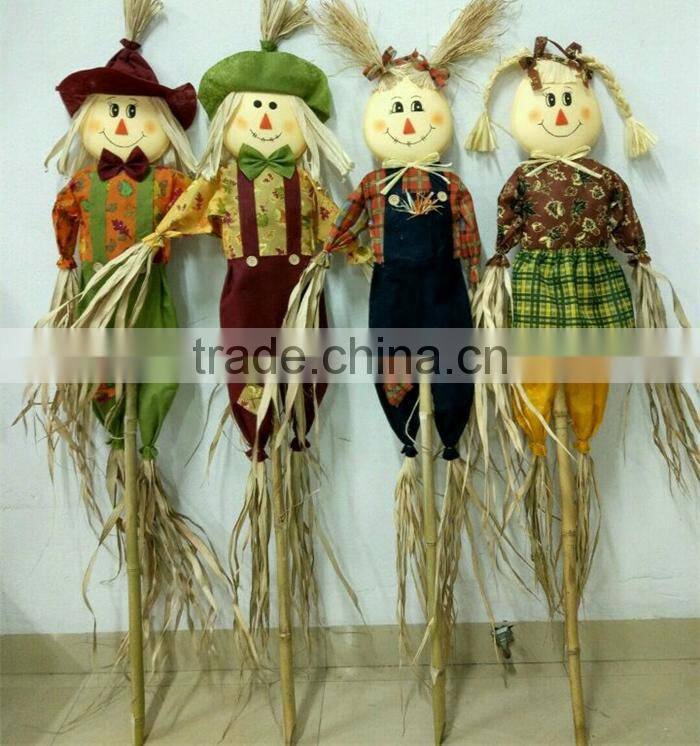 Paper straw and fabric scarecrow for autumn and harvest decoration