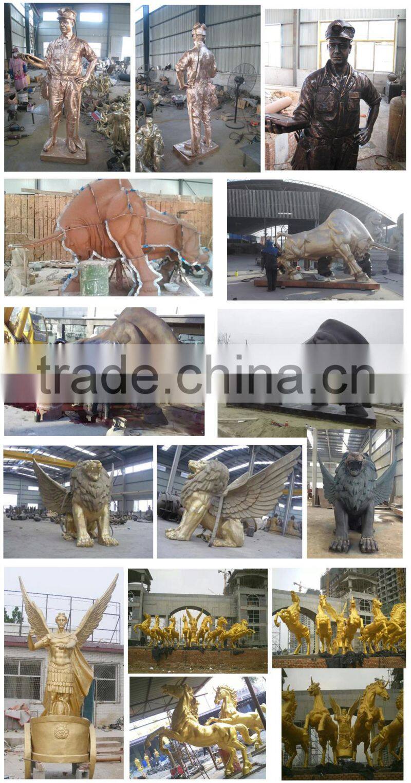 Garden playing boy and girl sculptures with teeterboard