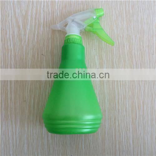 green plastic garden spray bottle with trigger