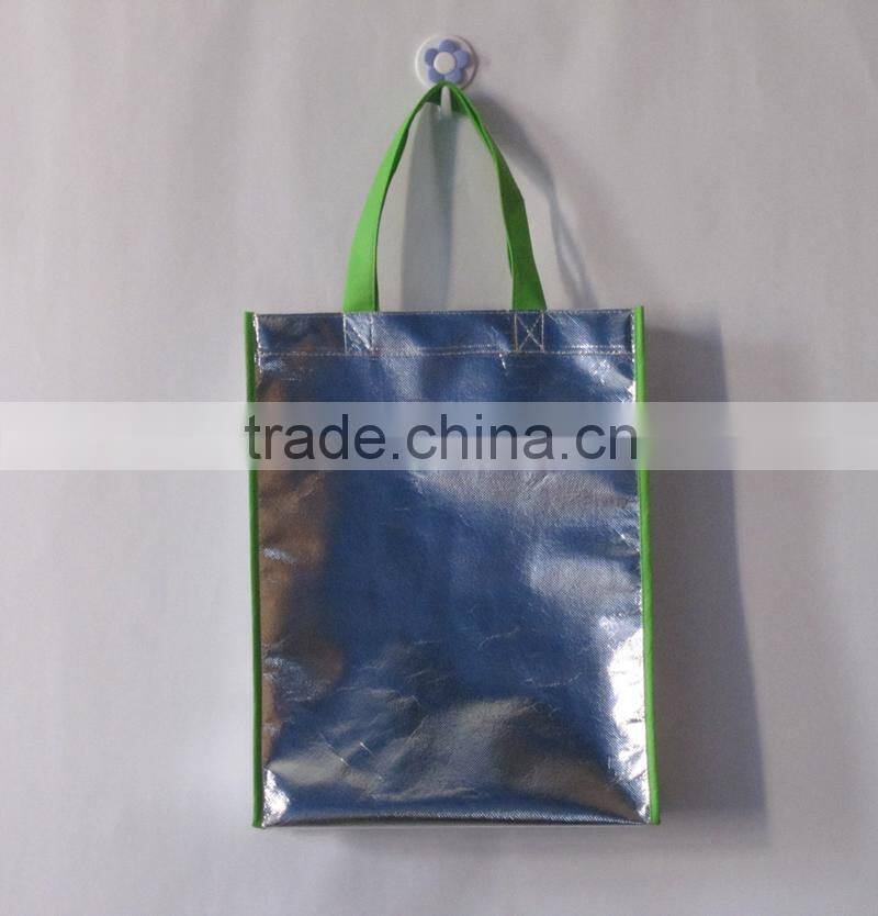Silver colour laser bag with gree handle