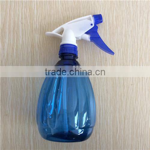blue transparent plastic garden spray bottle with trigger