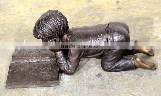 reading book on the ground boy bronze sculpture