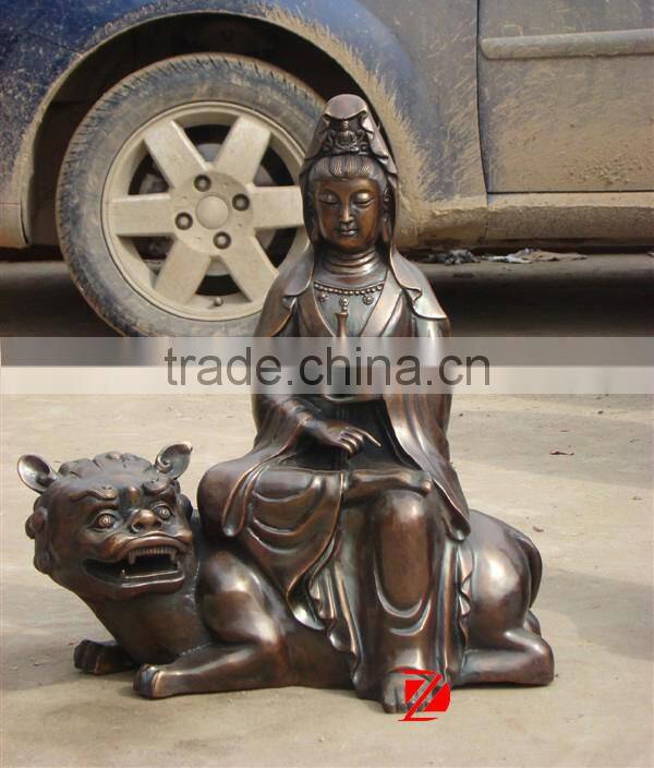 metal buddha statue sitting on tiger sculpture