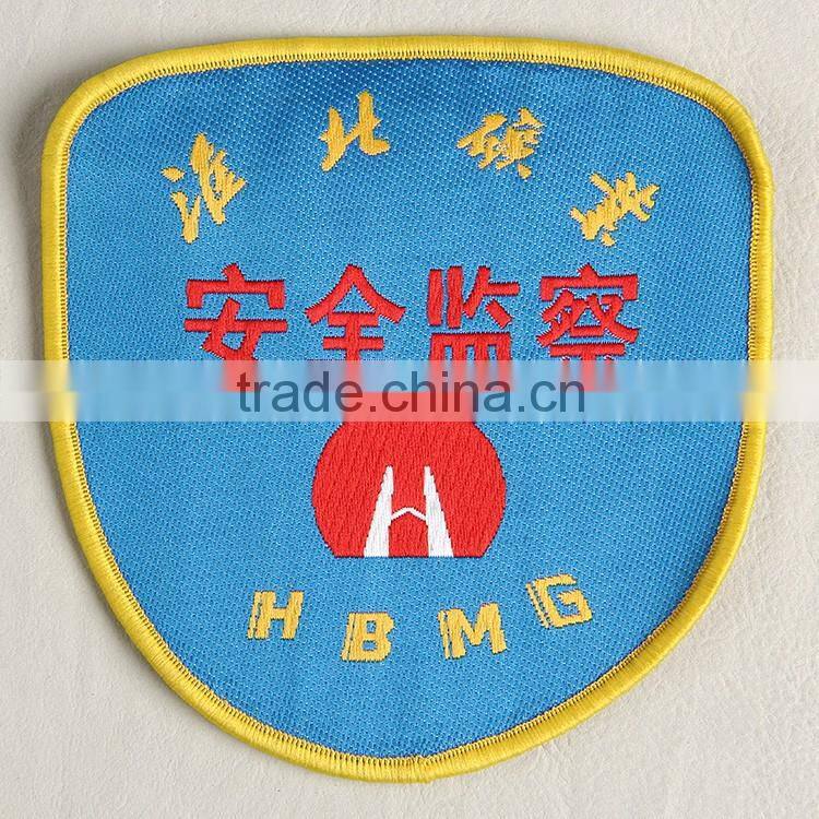 Woven badge with deep blue background for coal factory workwear