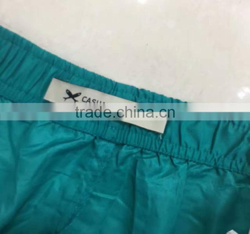 China stocklots men 100%polyester pure color bermuda shorts