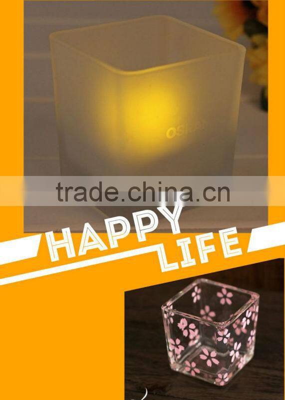 Glass candle holder with fabric cover