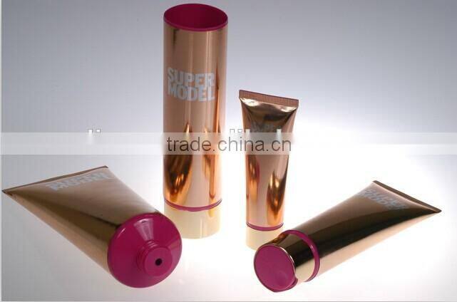 labeling collapsible empty tube with champagne aluminium cap