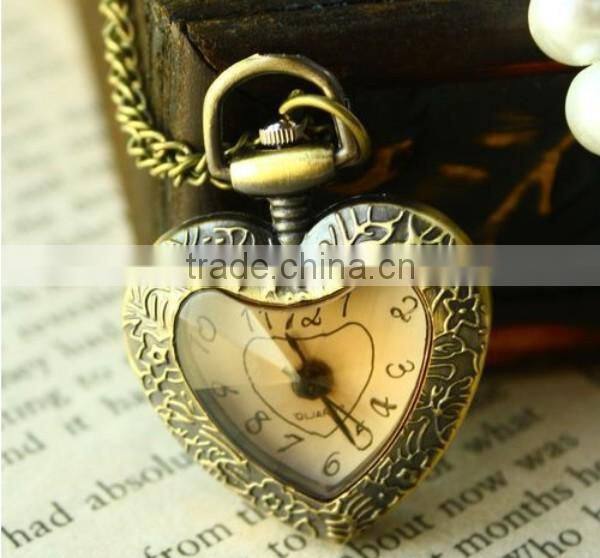 Cutting transparent glass heart shaped old pocket watch