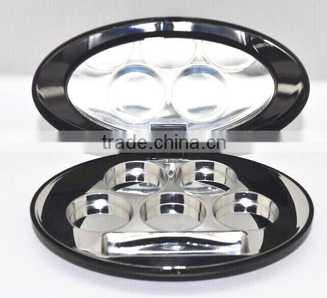 Oval shiny black compact container with shiny silver tray