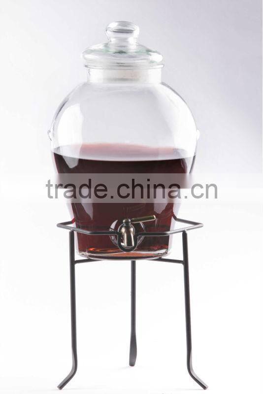 transparent round glass juice dispenser