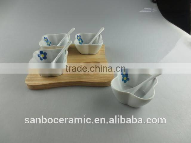 white porcelain clover-shaped dish set with spoon and wood tray