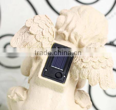 Resin solar lighting angle figurine holding a luminur glass globe garden ornamenet