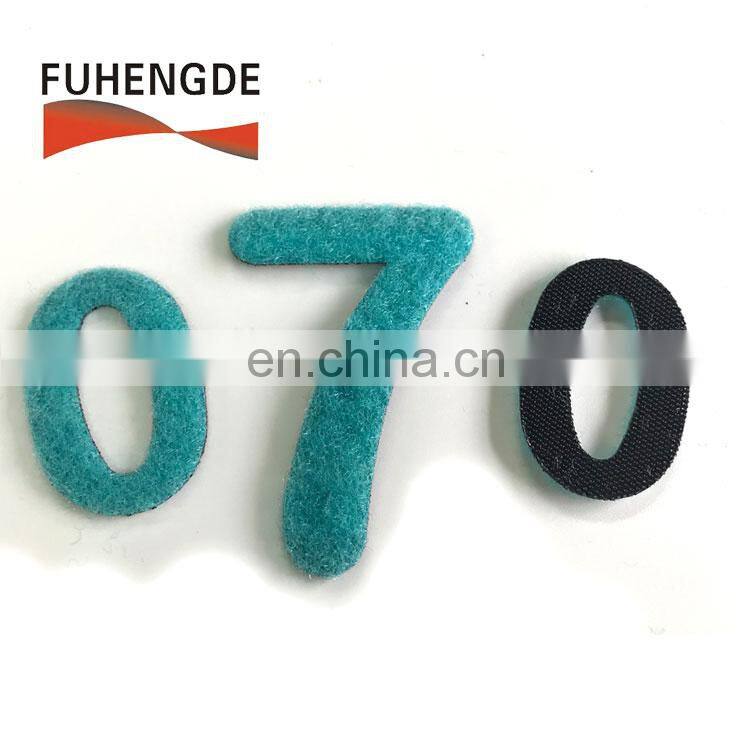 Green iron on towelling and fabric embroidery patch letters with hook loop backing fastening