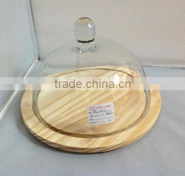 clear glass cake cover with white wood stand