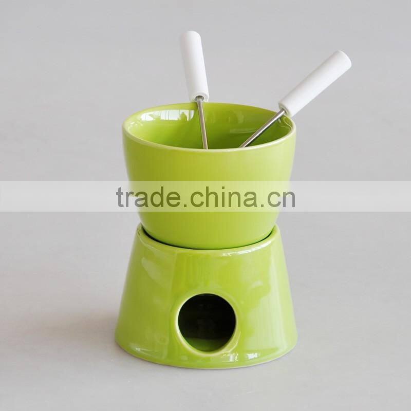 red color chocolate fondue set with forks and tea light