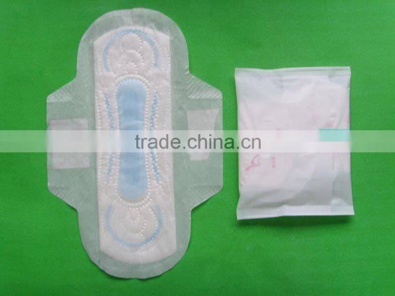 Disposable high absorbency dry surface sanitary napkin