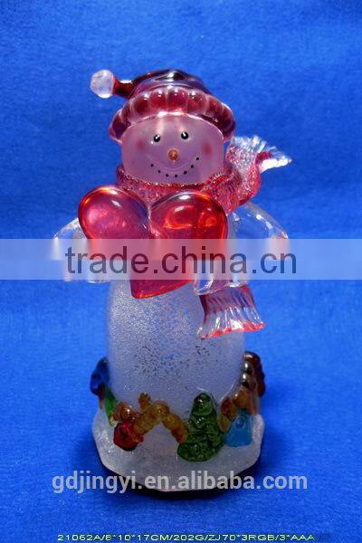 Holding a red heart acrylic snowman with LED Light