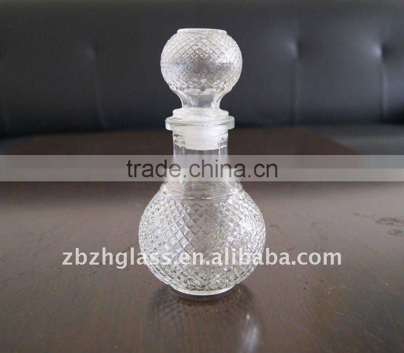 clear round glass wine bottle