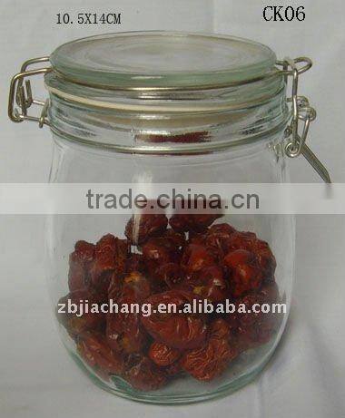 Clear glass food storage bottle with metal clip