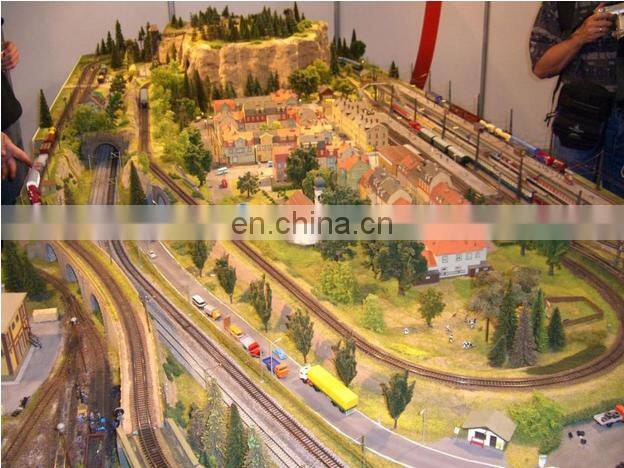 Ho scale model railroad with train cars and mini figures