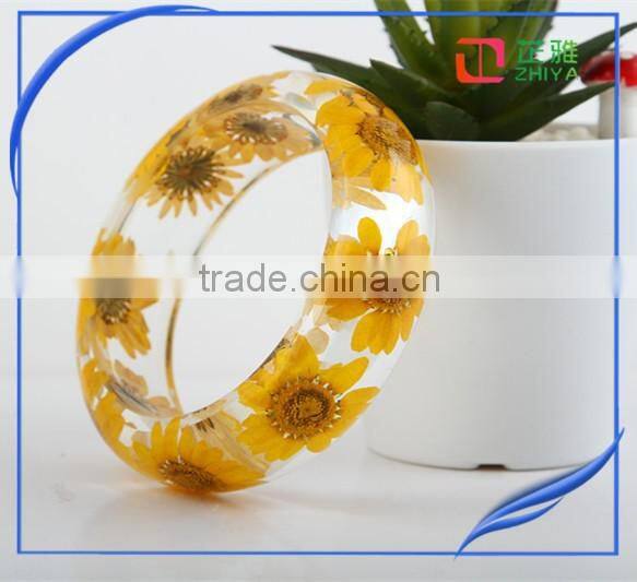 Pine needles inside transparent clear acrylic bangle stand