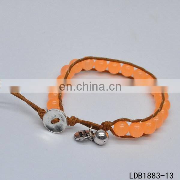 Handmade beaded wrap bracelet features 3 rows of circular and square stones surrounded by a natural colored cord on both sides