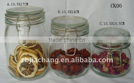 Clear glass food storage bottle with metal clip