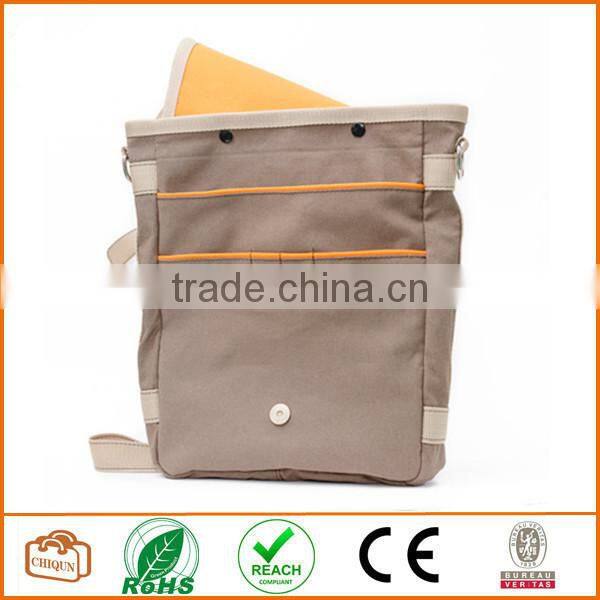 Unisex messenger bag and backpack. Brown Canvas with orange details and lining. Multiple pockets