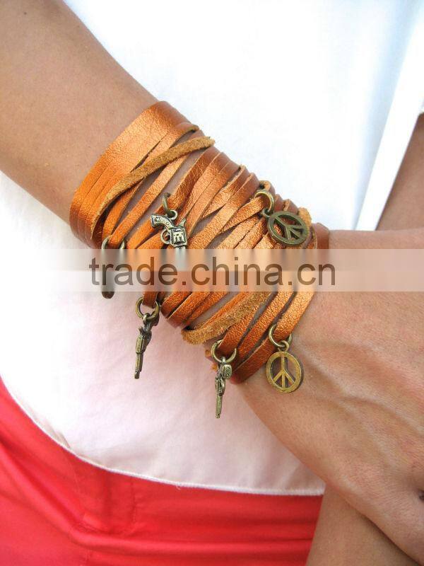 sliced leather bracelet, wide Leather Cuff - Charms Bracelet, Multi Strap Bracelet with peace and gun charms