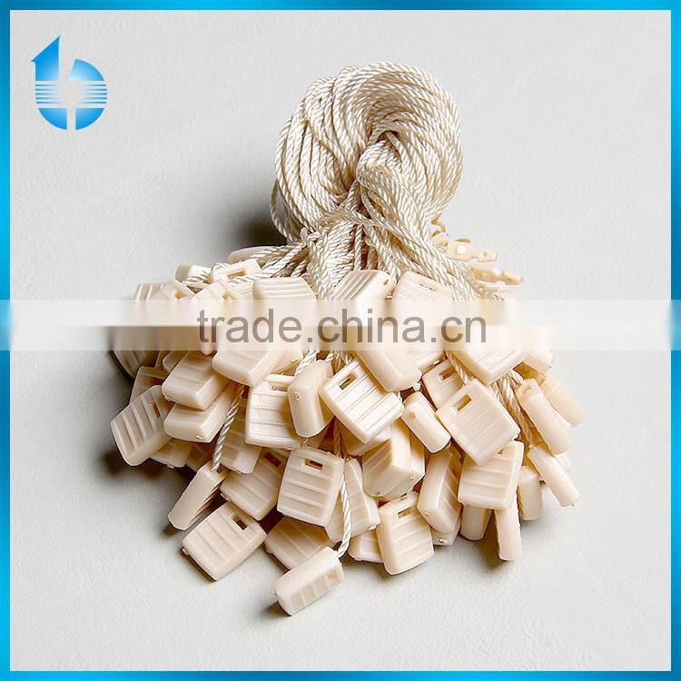 Plastic seal tag with string lock for deluxe garments