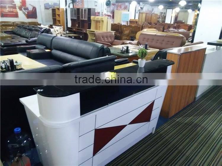 Black tufted reception desk made with tempered glass