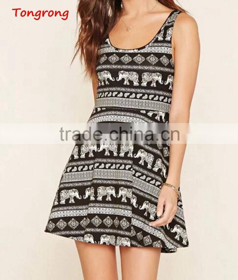 A sleeveless knit skater dress featuring an allover paisley and elephant print, crochet trim, short sleeves, and a round necklin