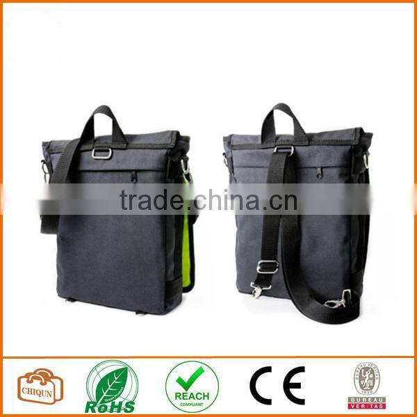 Unisex messenger bag and backpack. Dark Grey cotton canvas with green details and lining. Multiple pockets