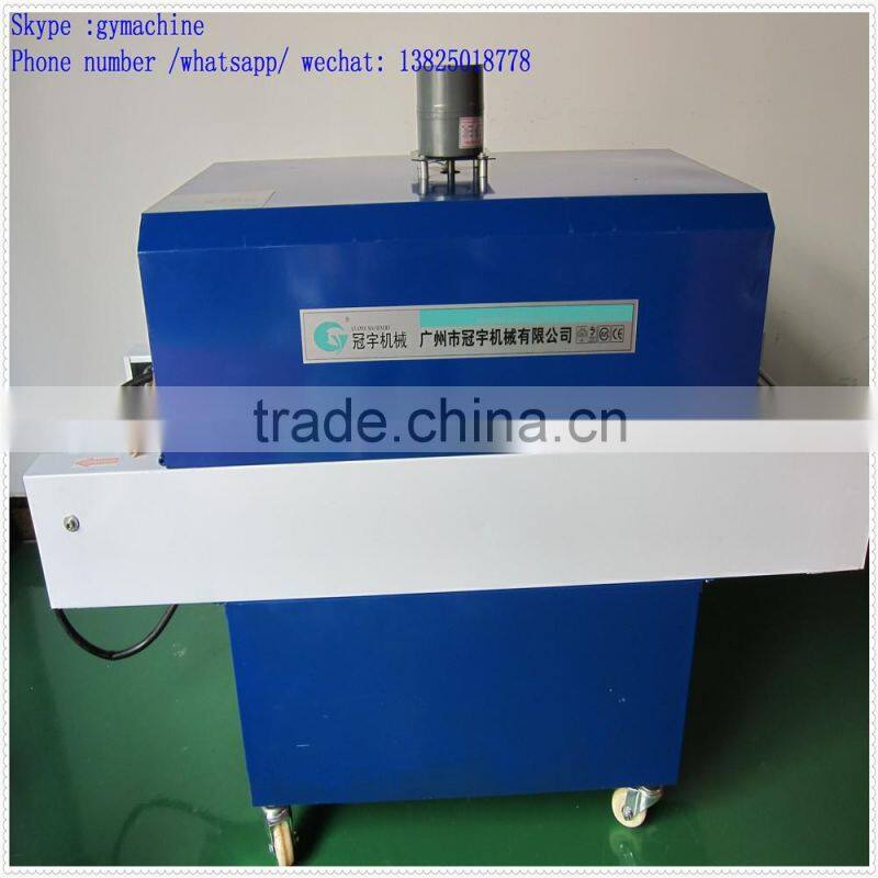 Automatic over wrapping heat shrinking machine