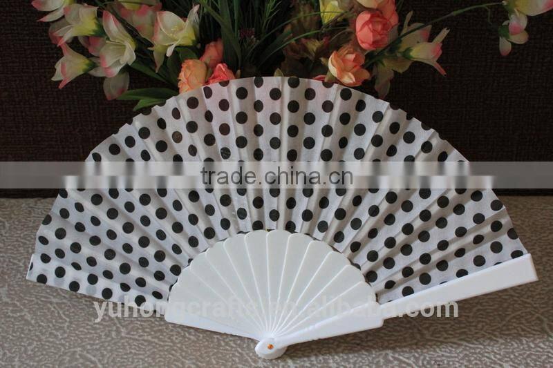 Plastic hand fan with dot design